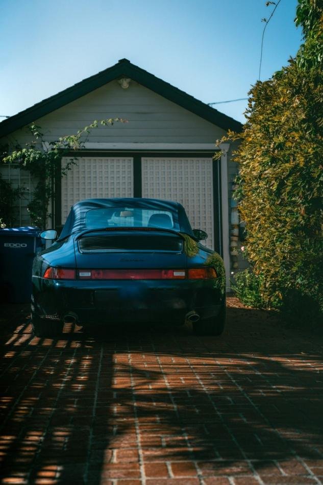 Premium car parked in front of a villa garage