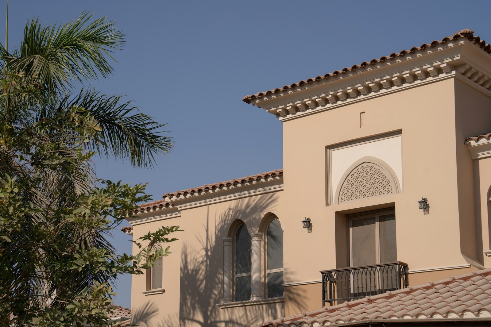 Tan Gulf-style building with palm trees in Al Wakra, Qatar