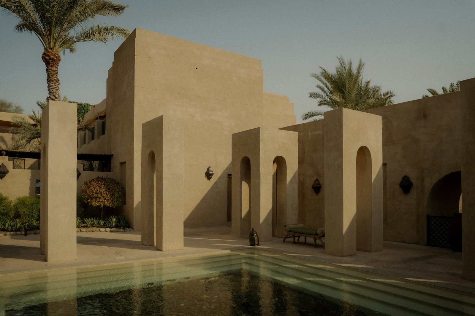 Gulf-style courtyard with arches and palm trees in Umm Salal, Qatar
